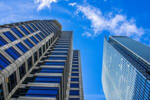 Large office buildings under a clear blue sky.