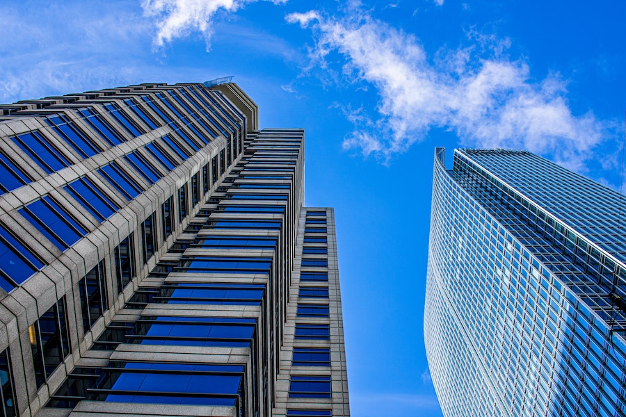 Large office buildings under a clear blue sky.