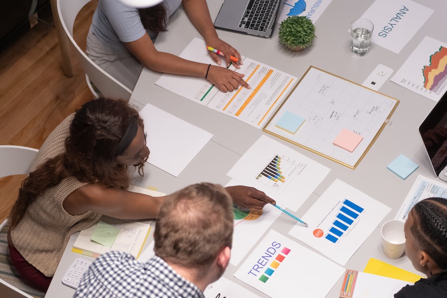 Staff looking over charts and reports.