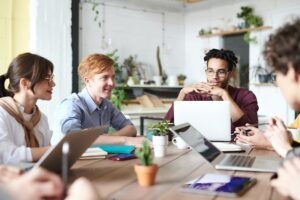 Young workers around a table having a meeting.