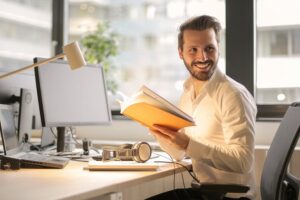 Man smiling at work station.