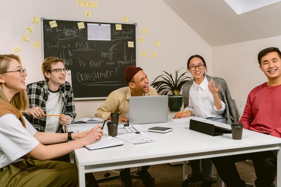 Team members laughing together in a work meeting.