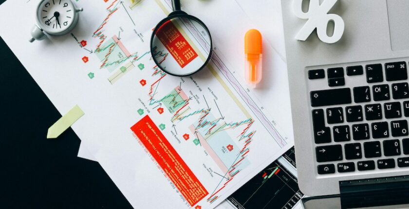 Desk filled with charts, tools, and computations.