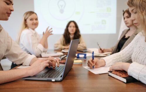 A group of coworkers sitting together at an all-staff meeting.