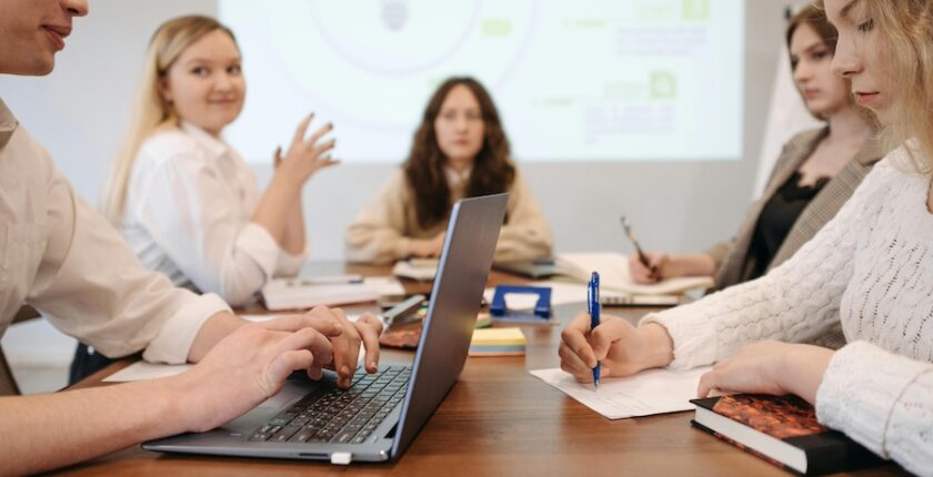 A group of coworkers sitting together at an all-staff meeting.