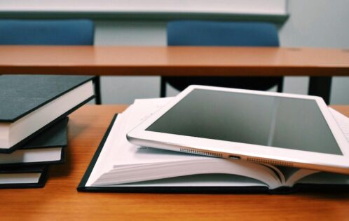 Books and a tablet on a table.