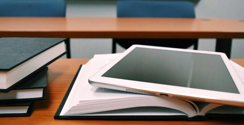 Books and a tablet on a table.