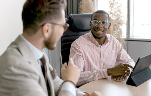 Two men talking in an office.