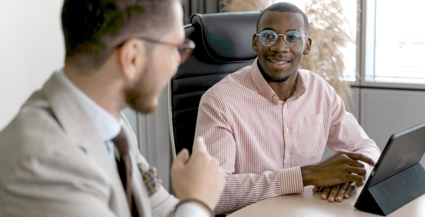 Two men talking in an office.