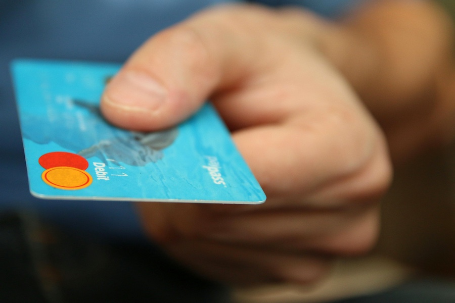 A hand holding a credit card.