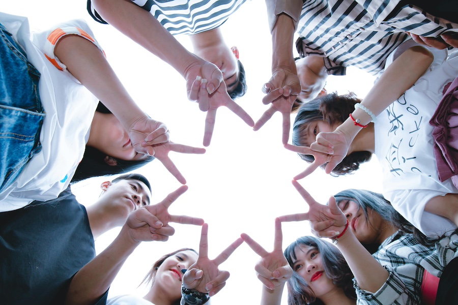 A star shape made with hands through teamwork.