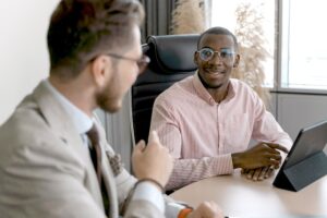 Two professionals talking in an office.