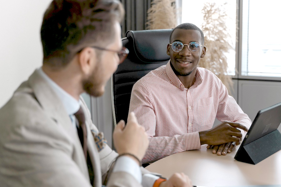 Two professionals talking in an office.