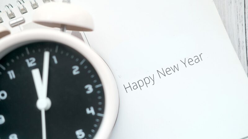 A happy new year message next to a clock.