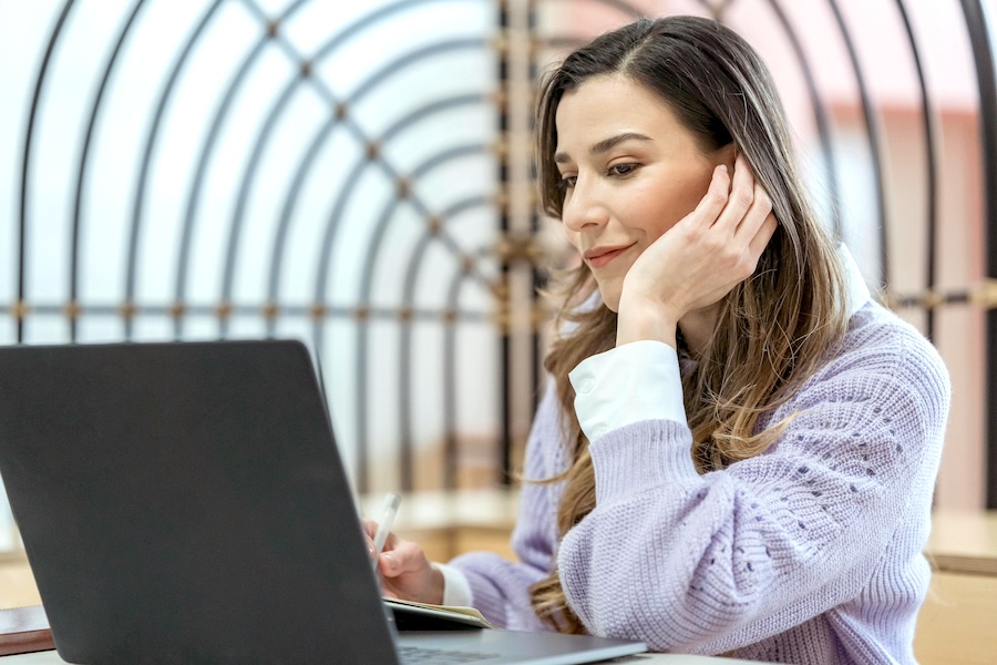 A job-seeking woman looking at her laptop.