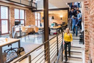 Workers walking down a stairwell in open concept office.