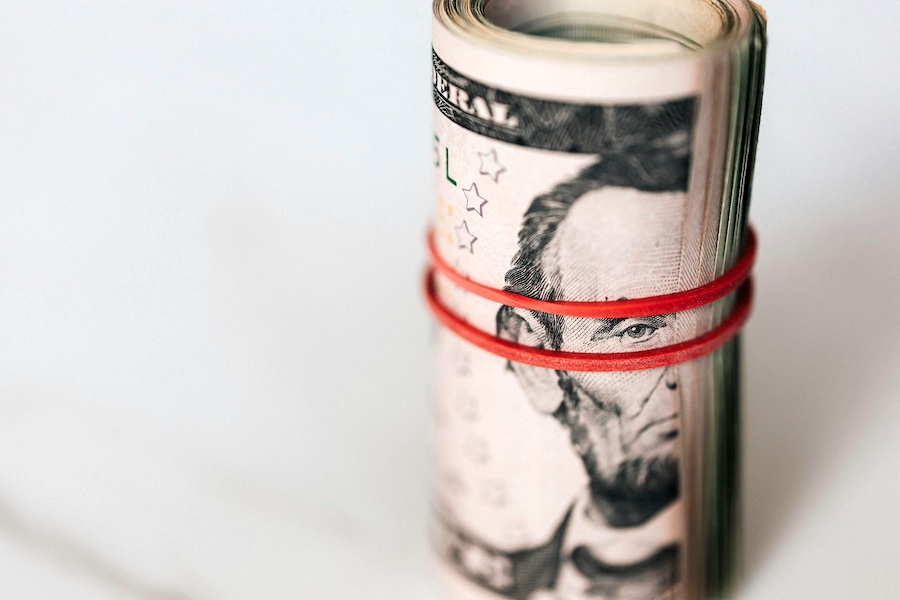 A roll of paper bills representing pay rates.