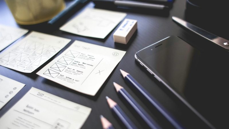 Notes, pencils, and technology on a table. In place for workforce planning.