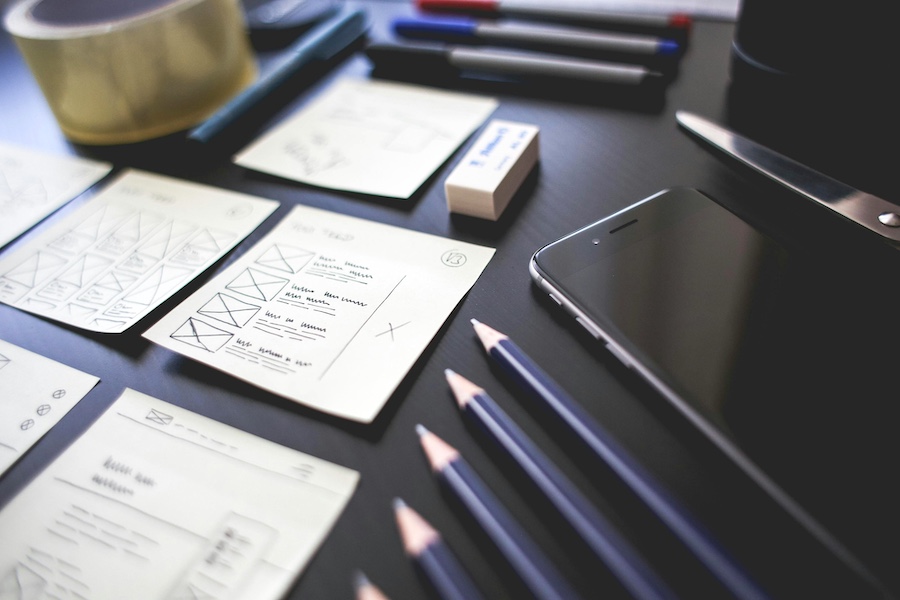 Notes, pencils, and technology on a table. In place for workforce planning.