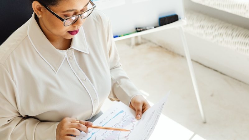 An office worker reviewing a data chart.