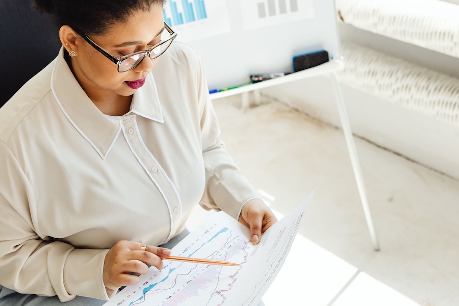 An office worker reviewing a data chart.