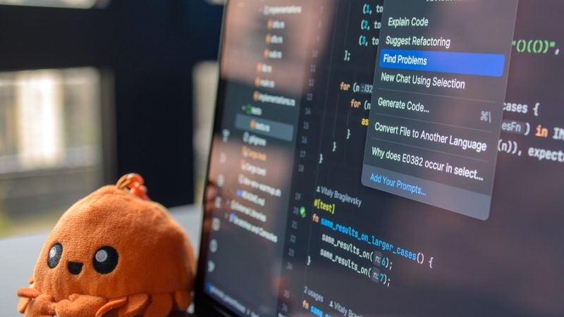 AI information on a laptop screen with a fun stuffed toy nearby.